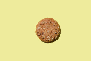 Dietary oatmeal cookies with  seeds on yellow background.