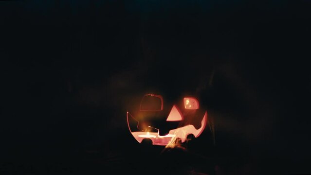 Monstrous halloween pumpkin with flashes as it rotates