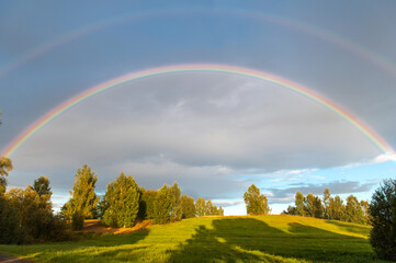 Rural landscape with double rainbow, autumn day after rain