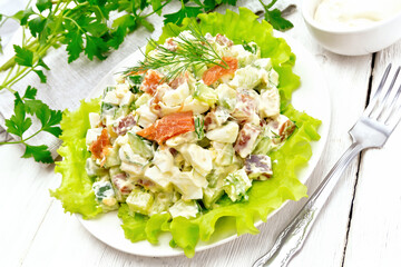 Salad of salmon and avocado with mayonnaise on wooden table