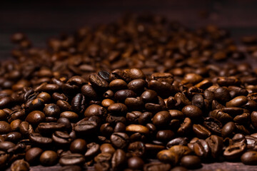 Dark background of roasted coffee beans.