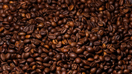 Dark background of roasted coffee beans.