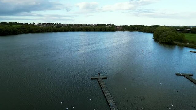 Man on a bridge operating drone