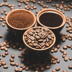 Freshly ground and prepared black coffee on a black background.