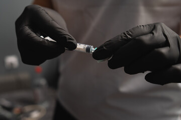 A close up of hands and blood draw process