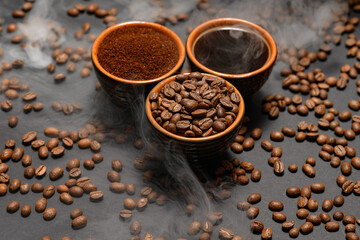 Cups of coffee and roasted coffee beans on a black background in a pair.