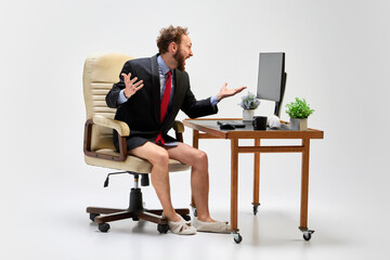 Express dissent. Young business man sitting at home and taking part at online meeting with...