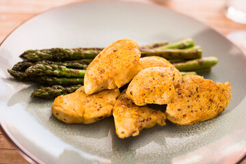 dietary meal rich in protein. Stir fried chicken breast and green asparagus