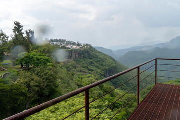 rusty old cable car, cable car ride in the rain, views of the canyon, vegetation and people. Mexico