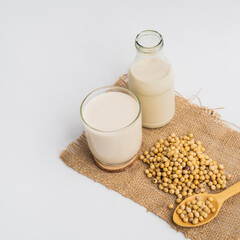 Health Benefits of Soy Milk,Soy milk in glass and soya bean isolated on white background