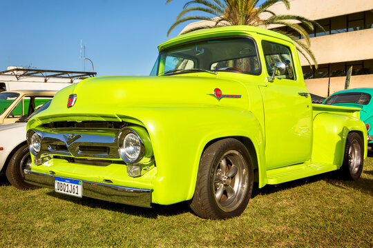 Vehicle Ford F100 1961 on display at vintage car show. V8 302 motor.