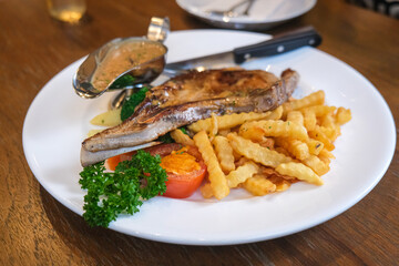 Pork chop steak with french fried on italian restaurant food
