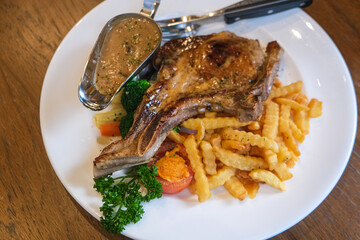 Pork chop steak with french fried on italian restaurant food