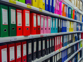 Kazan, Russia. September 22, 2022. Rows of colorful ledgers in an office supply supermarket. Set of color coded files and binders used by bookkeeper and accountant