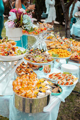 Festive table with buffet appetizers decorated with flowers