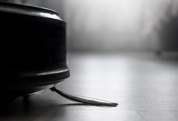 macro automated robot vacuum cleaner cleans the floor in the room. close up vacuum cleaner brush