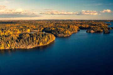 Autumn foliage colored trees, lake and islands in Heinola, Finland