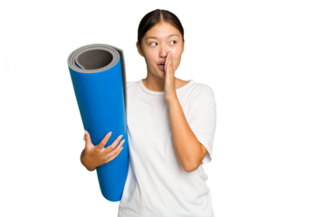 Young asian woman holding a mat isolated on green chroma background is saying a secret hot braking news and looking aside