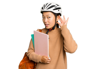 Young student asian woman wearing a bike helmet isolated on green chroma background trying to listening a gossip.