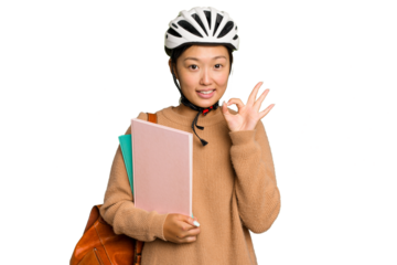 Young student asian woman wearing a bike helmet isolated on green chroma background cheerful and confident showing ok gesture.