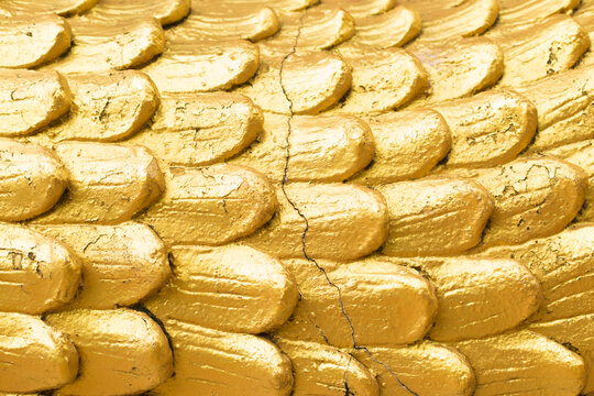 Golden scales with cracks close up surface