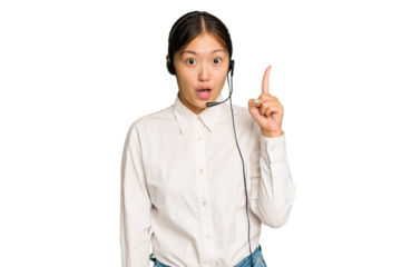Telemarketer asian woman working with a headset isolated on green chroma background having some great idea, concept of creativity.