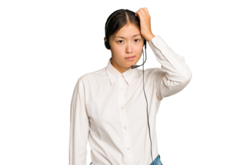 Telemarketer asian woman working with a headset isolated on green chroma background being shocked, she has remembered important meeting.