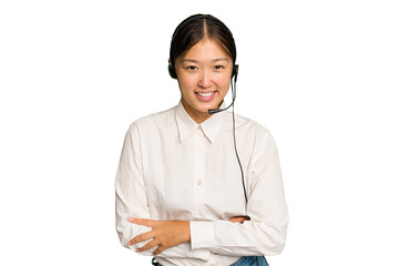 Telemarketer asian woman working with a headset isolated on green chroma background laughing and having fun.