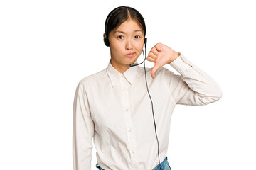 Telemarketer asian woman working with a headset isolated on green chroma background showing a...