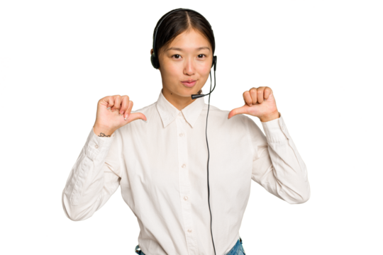 Telemarketer asian woman working with a headset isolated on green chroma background feels proud and self confident, example to follow.
