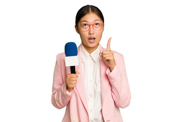 Young TV Asian presenter isolated on green chroma background pointing upside with opened mouth.