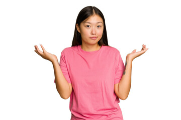 Young Asian woman isolated on green chroma background doubting and shrugging shoulders in...