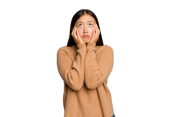 Young Asian woman isolated on green chroma background whining and crying disconsolately.