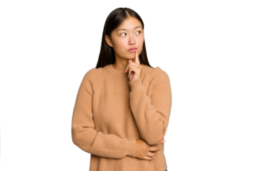 Young Asian woman isolated on green chroma background contemplating, planning a strategy, thinking about the way of a business.