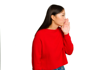 Young Asian woman isolated on green chroma background is saying a secret hot braking news and looking aside