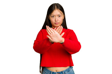 Young Asian woman isolated on green chroma background standing with outstretched hand showing stop...