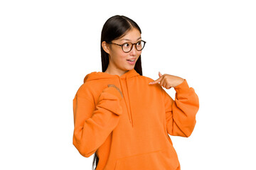 Young Asian woman isolated on green chroma background surprised pointing with finger, smiling broadly.