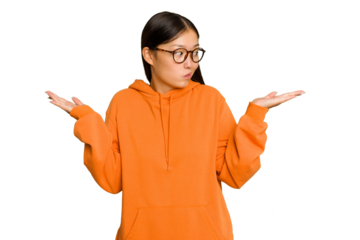 Young Asian woman isolated on green chroma background confused and doubtful shrugging shoulders to hold a copy space.