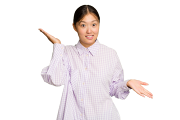 Young Asian woman isolated on green chroma background confused and doubtful shrugging shoulders to hold a copy space.