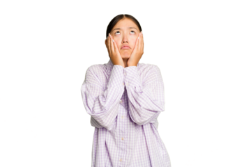 Young Asian woman isolated on green chroma background whining and crying disconsolately.