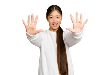 Young Asian woman isolated on green chroma background showing number ten with hands.