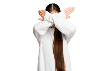 Young Asian woman isolated on green chroma background keeping two arms crossed, denial concept.