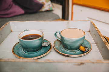 traditional black coffee and cappuccino on a tray. Coffee cups on a tray in a cafe. hot drinks. time for coffee.