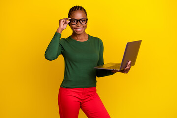 Photo of charming sweet young woman wear green shirt spectacles working modern device isolated yellow color background