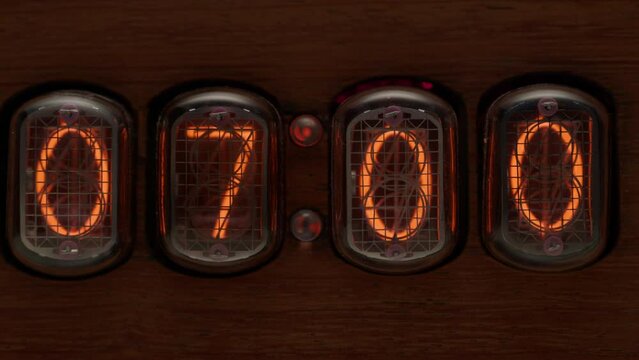 Vintage clock showing 06.59 changing to 07.00 o'clock. Alarm clock at 7 a.m. - time to wake up.