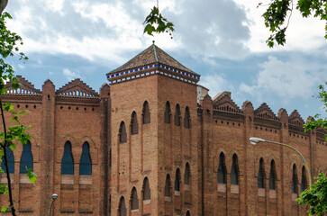 Fototapeta na wymiar Medieval brick castle in Spain. Beautiful old red brick building on a sunny summer day.