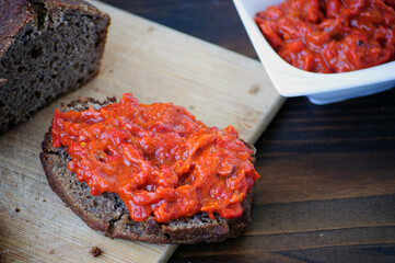 Homemade whole grain einkorn bread, a slice with Lutenitza and a cup with Lutenitza. Traditional bulgarian food.