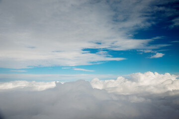 Fototapeta na wymiar Above clouds from airplane window