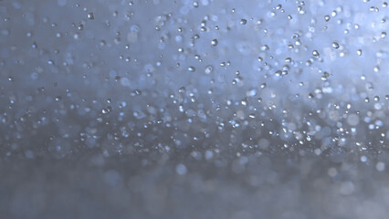 3D rendering of crystal clear particles cascading, resembling rain droplets colliding with the ground in bright blue foggy environment with bokeh background 