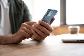 Close up of male hands with mobile. Man pointing on smartphone screen, chatting in social networks